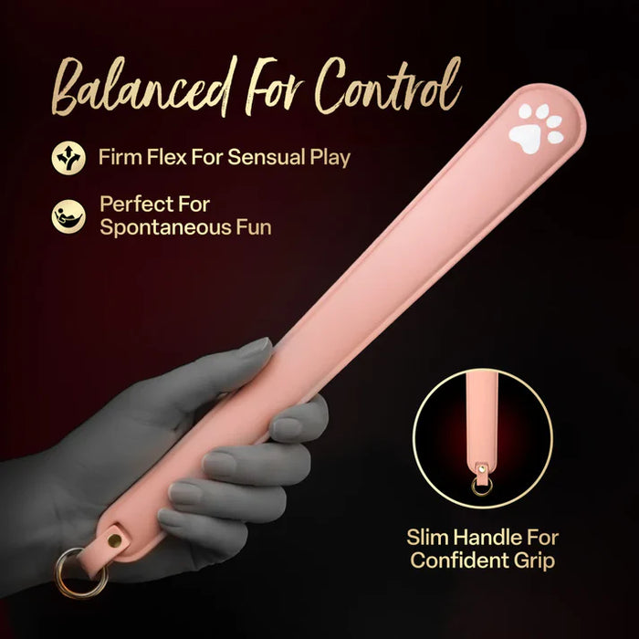 Hand holding the Temptasia Ardor Slapper by Blush silicone paddle with text highlighting firm flex design, slim handle grip, and sensual impact play features.