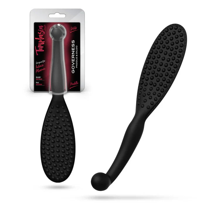 Temptasia Governess Paddle Dildo by Blush in black silicone with textured paddle surface and curved handle, shown alongside retail packaging and angled product view.