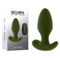 green vibrating anal plug with tapered head and wide base bottom beside display box