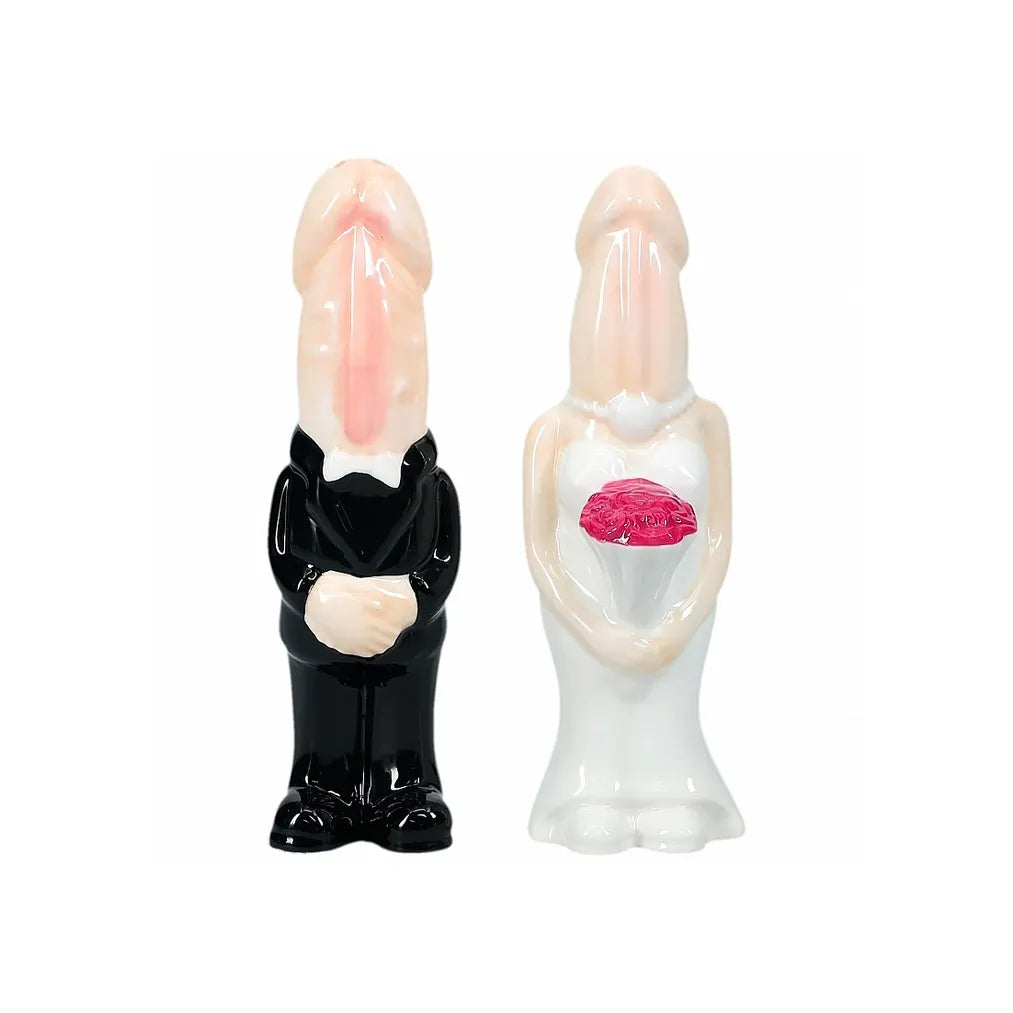 Two ceramic dickhead figures, one in a suit and the other in a dress, on a white background.