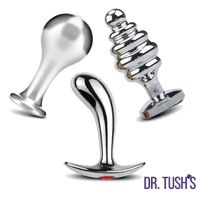 Dr. Tush’s Tools of Temptation Collection featuring three polished silver metal anal plugs in Knob, Prostate and Hive shapes with flared bases.