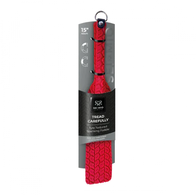 a red tire tread paddle with silver accents shown with its black packaging