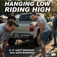 Two men leaning against a truck with text 'Hanging Low Riding High' and 'If it ain't swingin', you ain't winning!' in front of a crowd.