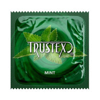 Green packaging of Trustex Mint condoms with mint leaves on a white background