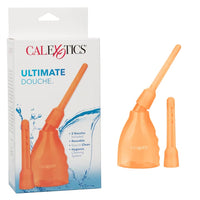 a orange squeeze bottle with an angled nozzle. It is next to a second nozzle attachment and its white display box