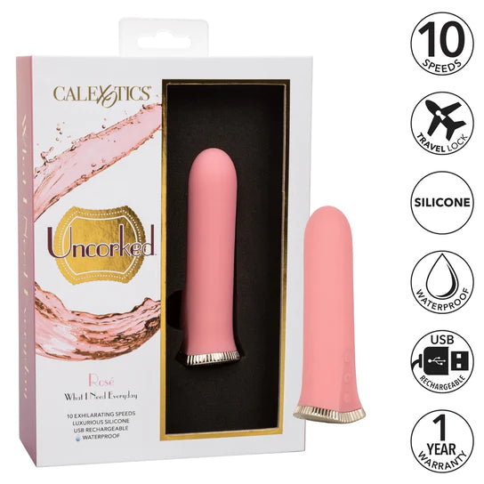 a pink stubby vibrator with a gold base and pink function buttons, shown next to its white display box and key features