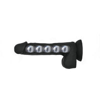 Black textured silicone adult novelty accessory with four clear domed lenses, shown against a plain white background.