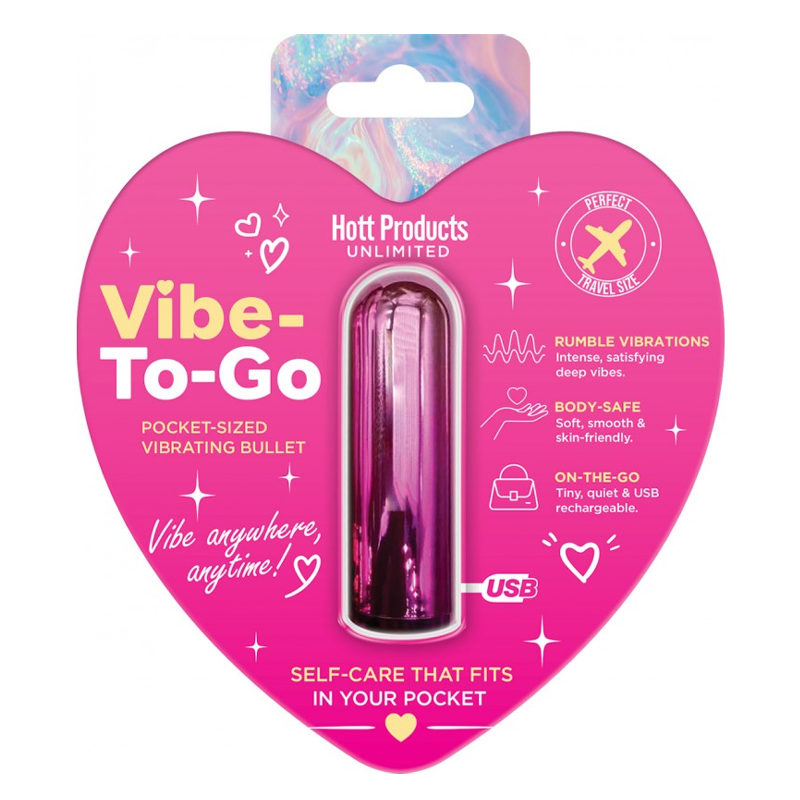 A pink heart-shaped retail package containing a small USB vibrating bullet. The packaging is bright pink with white and yellow text and decorative icons, and the bullet inside is metallic pink.