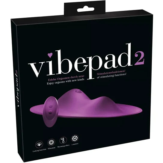 a black display box depicting a purple flat surface vibrator with two large raised bumps. The largest of the two bumps has a tongue flicker. There is also a purple remote control