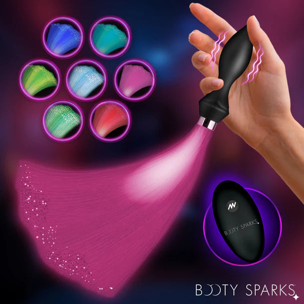 Hand holding a fiber optic anal plug with colorful light effects and 'Booty Sparks' branding.