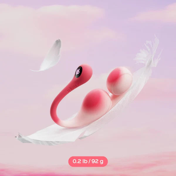 A pink dual-stimulation personal massager floating on white feathers against a soft pink sky background, with a text label reading '0.2 lb / 92 g' at the bottom.