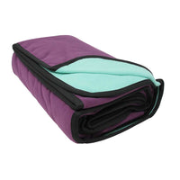 Folded blanket with purple exterior and light blue interior on a white background