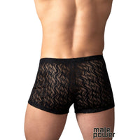 Rear view of a male model wearing black lace boxer briefs with a wavy pattern, on a white background.
