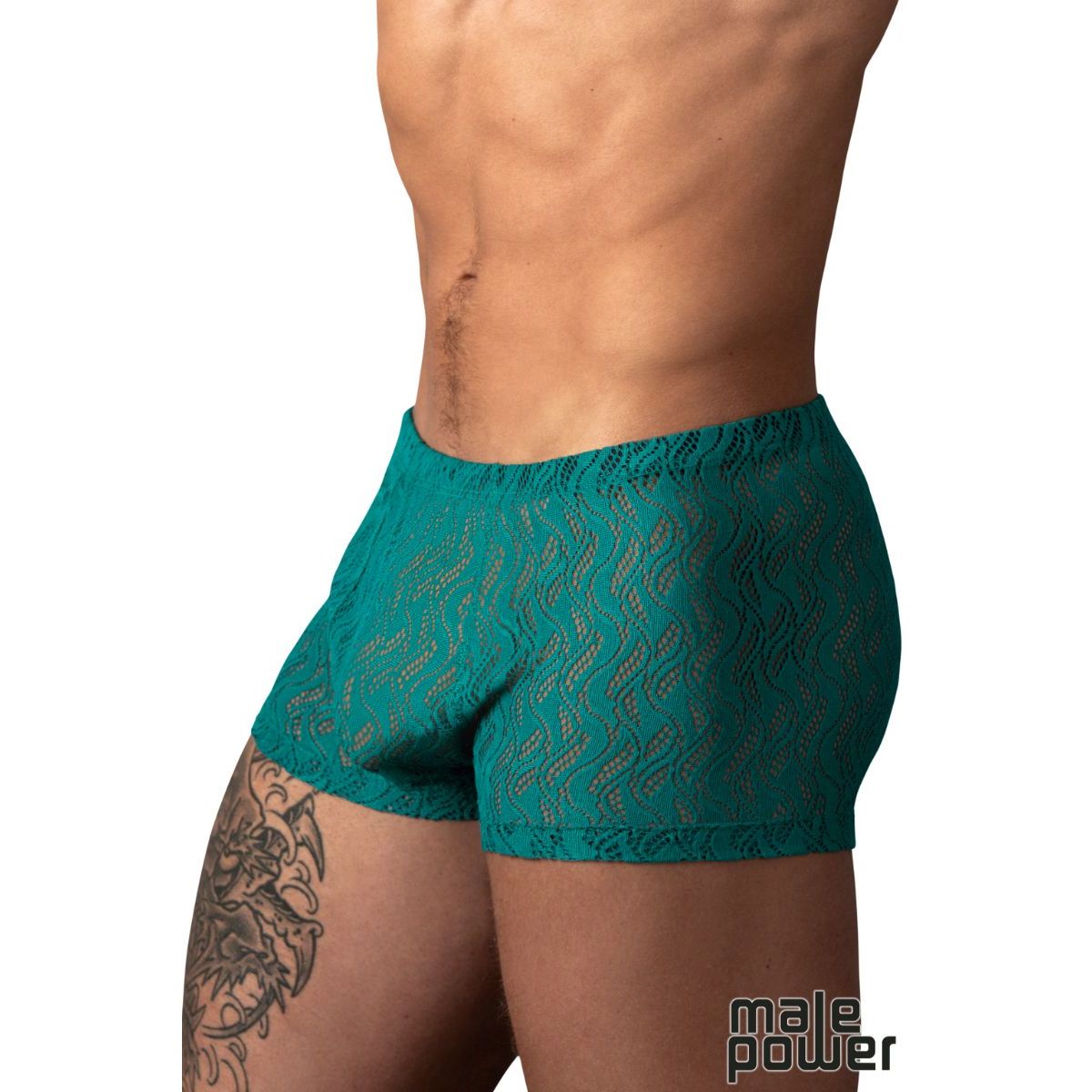 A close-up of a male model's lower torso wearing teal lace boxer briefs with a wavy pattern, against a plain white background. A 'male power' logo is visible in the bottom right corner.
