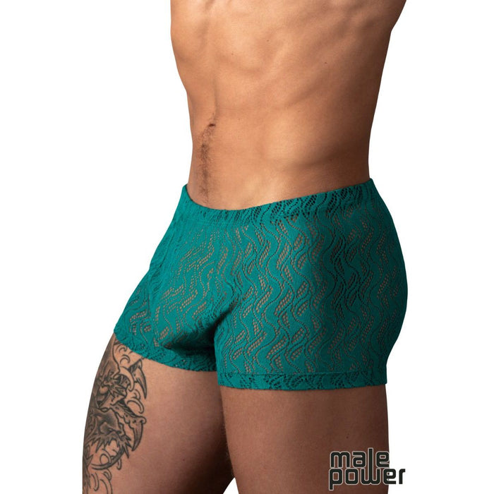 A close-up of a male model's lower torso wearing teal lace boxer briefs with a wavy pattern, against a plain white background. A 'male power' logo is visible in the bottom right corner.
