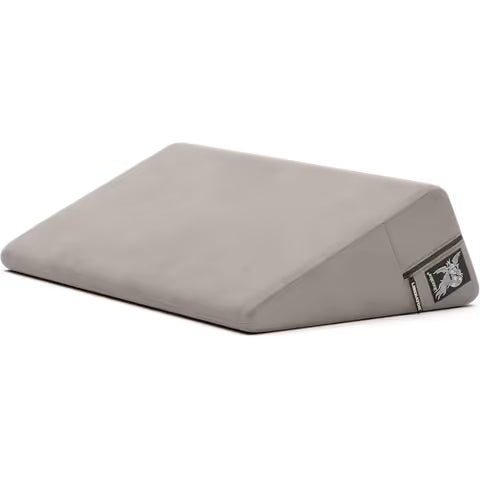 Gray wedge pillow with a liberator logo on a white background