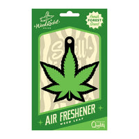 A packaged cardboard air freshener designed to look like a green weed leaf, with the brand Wood Rocket visible.