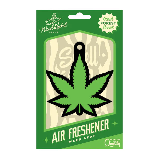 A packaged cardboard air freshener designed to look like a green weed leaf, with the brand Wood Rocket visible.