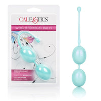 teal dual kegel ball with tail next to package