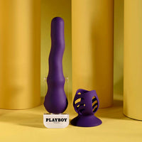 Purple silicone vibrator with 'Playboy' branding on a yellow background