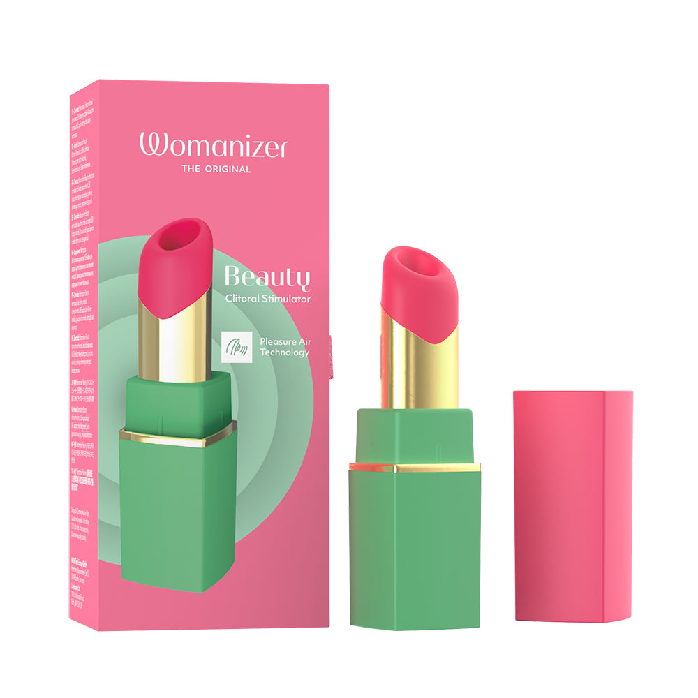 A cosmetic lipstick vibrator product shown with its pink retail box, the lipstick bullet exposed, and the cap standing beside it on a white background. The packaging and product design feature bright pink and mint green, with a metallic gold band.