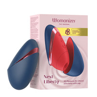 womanizer next liberty clitoral vibrator beside box packaging in navy