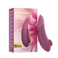 Womanizer next clitoral vibrator with packaging on a white background