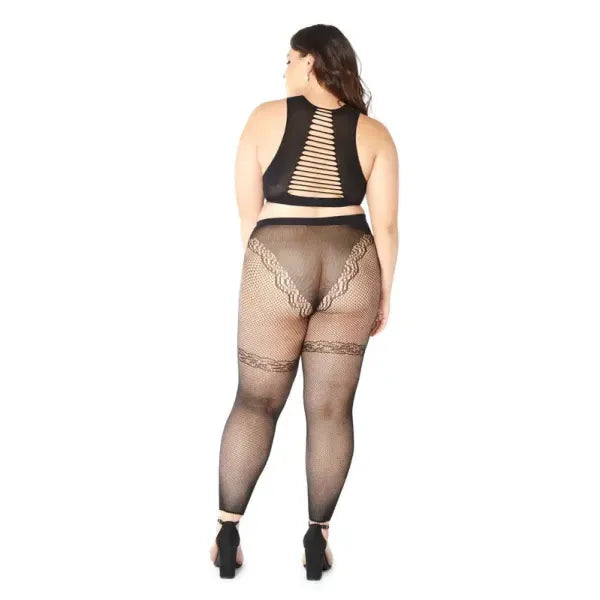 Person wearing black lace lingerie set on a white background