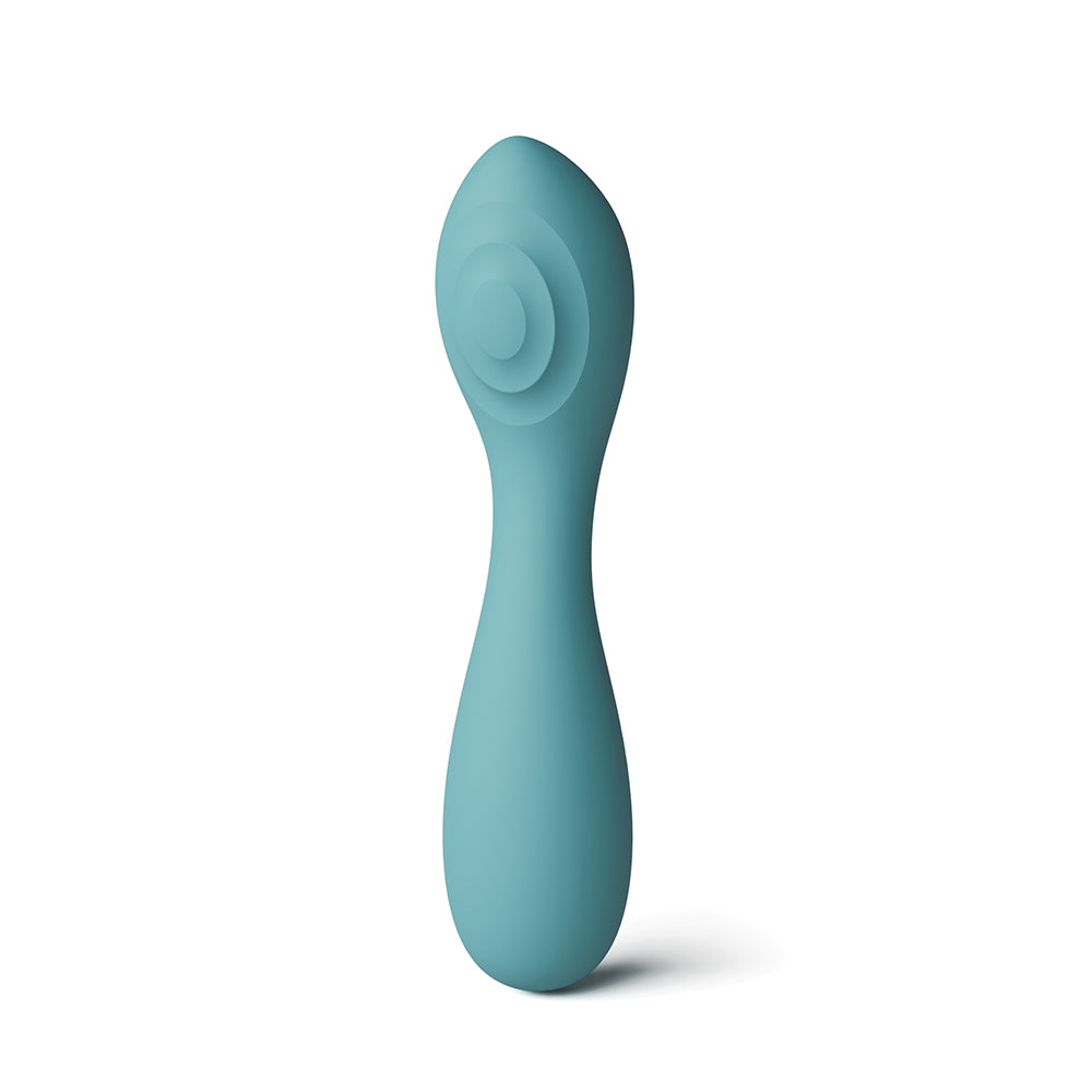 A teal silicone personal massager with a curved handle and concentric circular design on the head, shown against a plain white background.