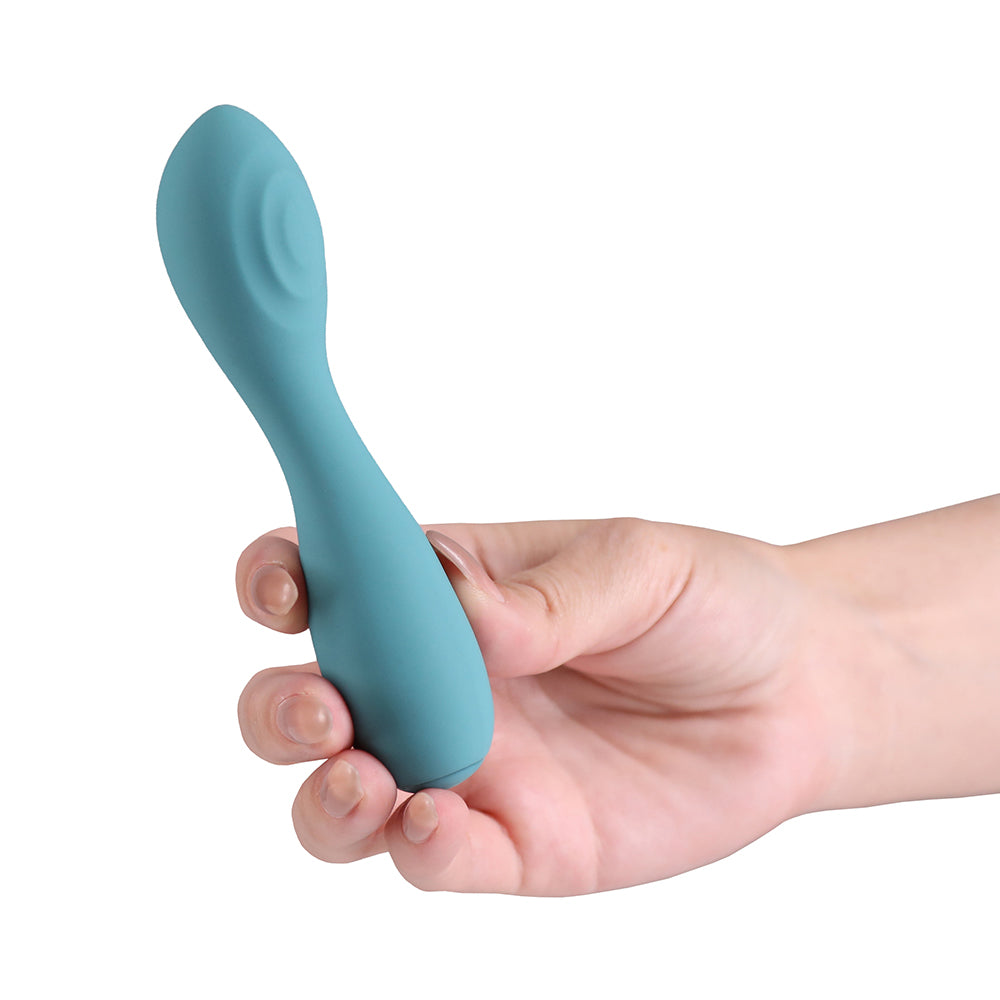 A teal silicone personal massager held in a person's hand against a plain white background.