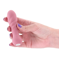 hand holding pink vibrator on white back ground