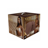 A boxed product package for Xkin body care, shown at a three-quarter angle on a white background. The box is dark brown with gold lettering and features printed photos of a woman wearing beige lingerie and a large image of a brown panty on the front.