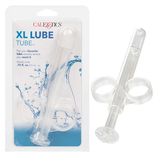 There is a clear lube dispensing syringe with two finger loops. It is shown next to its plastic packaging.