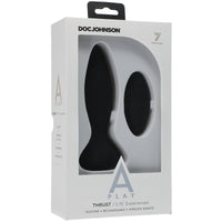 The image shows the product packaging for the Doc Johnson A-Play Thrust Vibrating Anal Remote Control. The box is predominantly white with a clear window displaying the black silicone anal plug and the remote control.