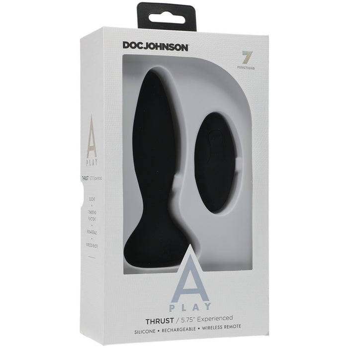 The image shows the product packaging for the Doc Johnson A-Play Thrust Vibrating Anal Remote Control. The box is predominantly white with a clear window displaying the black silicone anal plug and the remote control.