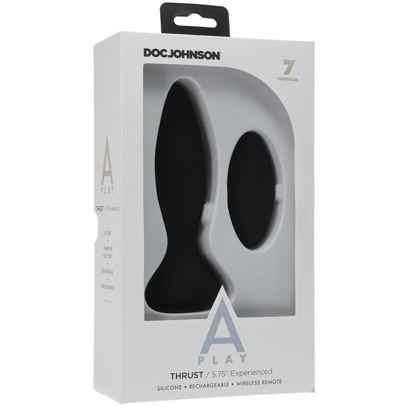 The image shows the product packaging for the Doc Johnson A-Play Thrust Vibrating Anal Remote Control. The box is predominantly white with a clear window displaying the black silicone anal plug and the remote control.