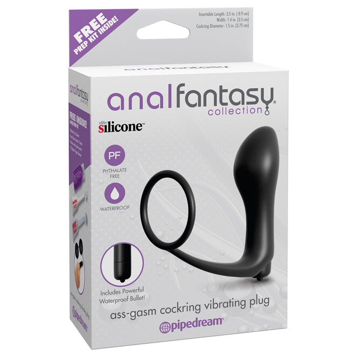 The image shows the packaging of the Anal Fantasy Ass Gasm Vibrating Anal Plug by Pipedream Products. The box is predominantly black and purple, with a clear window displaying the black silicone anal plug with a cock ring.