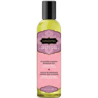 A bottle of Kama Sutra Aromatic Massage Oil with a label that has a pink and green color scheme and text indicating it is for 'Pleasure Garden'.