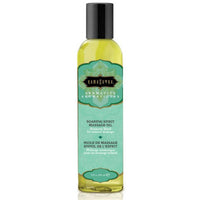 A bottle of Kama Sutra Aromatic Massage Oil with a label that has a green and white color scheme and text that includes 'Soaring Spirit' and an image of a rose.