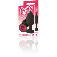 The product image shows the packaging of the Booty Calls anal plug, which is black and shaped like a classic plug with a smooth, rounded design. The packaging is pink and features the product name and branding details.