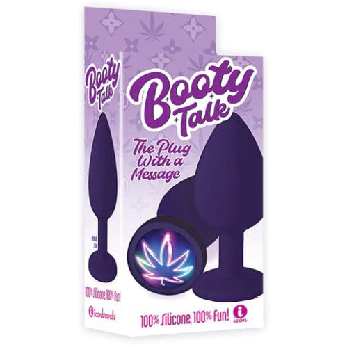 The product packaging showcases the Booty Talk anal plug with a neon leaf design, emphasizing its smooth silicone material and purple color. The packaging is vibrant with purple and pink colors and displays the text 'The Plug with a Message' along with the brand 'Icon Presents'.