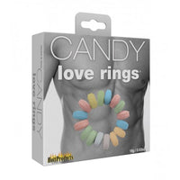The image shows the packaging of the Candy Cock Ring's 3pk by Hott Products. The package displays a graphic of a male torso with multiple colored candy rings worn around the penis.
