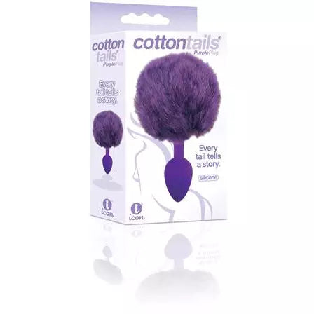 The product image shows the packaging of the Cotton Tails Anal Plug, with the plug itself visible. The plug is purple, with a fluffy white fur attachment, and is shown in a clear plastic package with branding and product information.