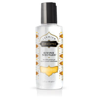 A bottle of Divine Nectars Body Glide with a Coconut Pineapple flavor by Kama Sutra. The bottle is clear with a black cap and adorned with yellow and white label featuring pineapple imagery.