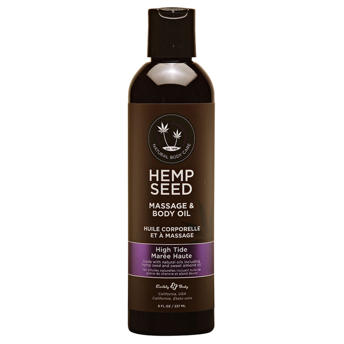 A bottle of Earthly Body Hemp Seed Body & Massage Oil in High Tide scent. The bottle is dark glass with a white and purple label.