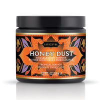 A container of Honey Dust kissable body powder with a Tropical Mango fragrance by Kama Sutra, featuring a colorful label with a floral pattern.