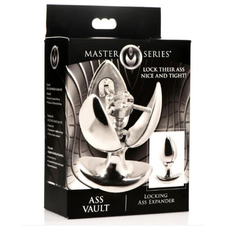 The product image shows the packaging of the Master Series Ass Vault Locking Ass Expander. The box features a black and silver design with images of the stainless steel anal plug and the key, emphasizing its locking mechanism and temperature sensitivity.