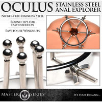 The image shows a set of stainless steel anal exploration tools, including one large ring and six dilators with smooth rods and round balls on the ends. The dilators are adjustable using wingnuts.
