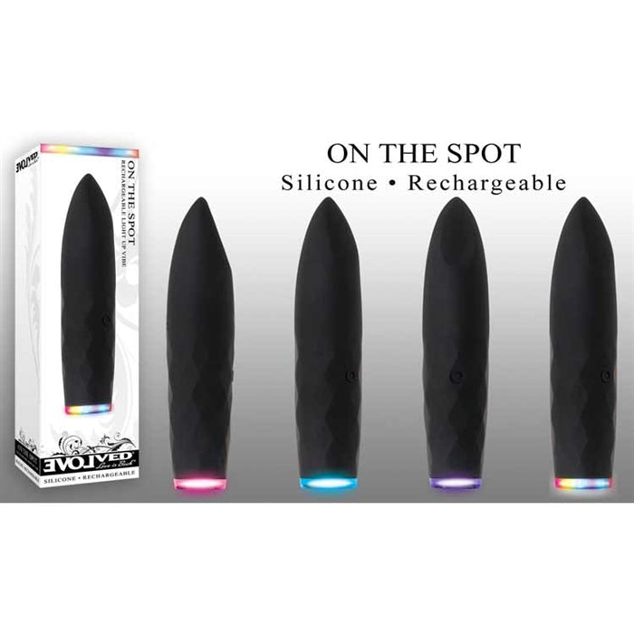 The image shows a set of four black silicone bullet vibrators with a smooth plane tip. They are displayed horizontally with a focus on the textured base, and illuminated by LED lights at the bottom, which are multicolored and change with each function.