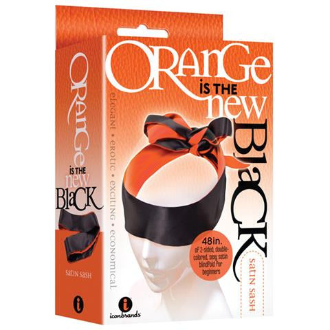 A packaged satin sash blindfold with orange and black colors displayed on the packaging, labeled 'Orange Is The New Black'.